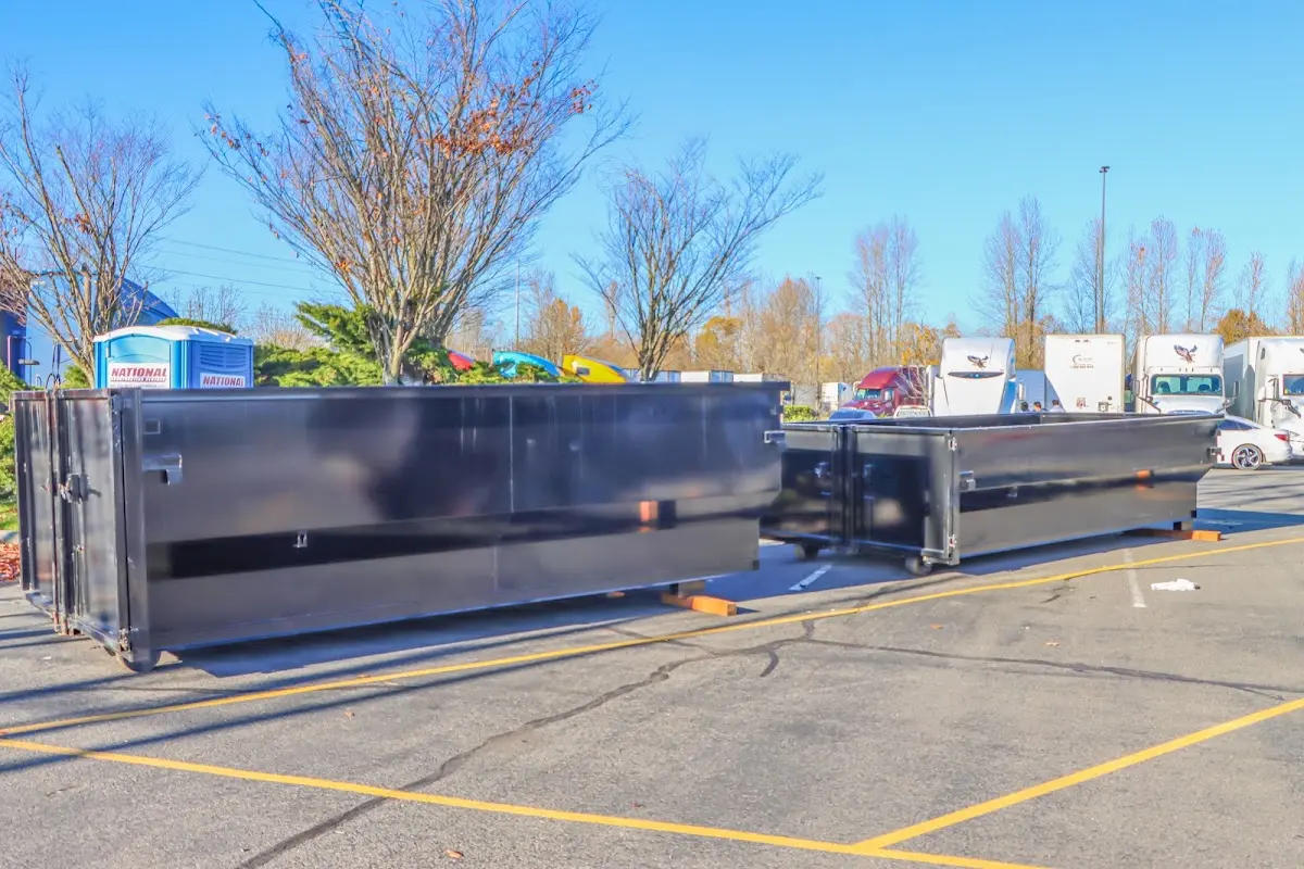 Professional dumpster rental service with roll-off container on residential driveway in Martinsburg